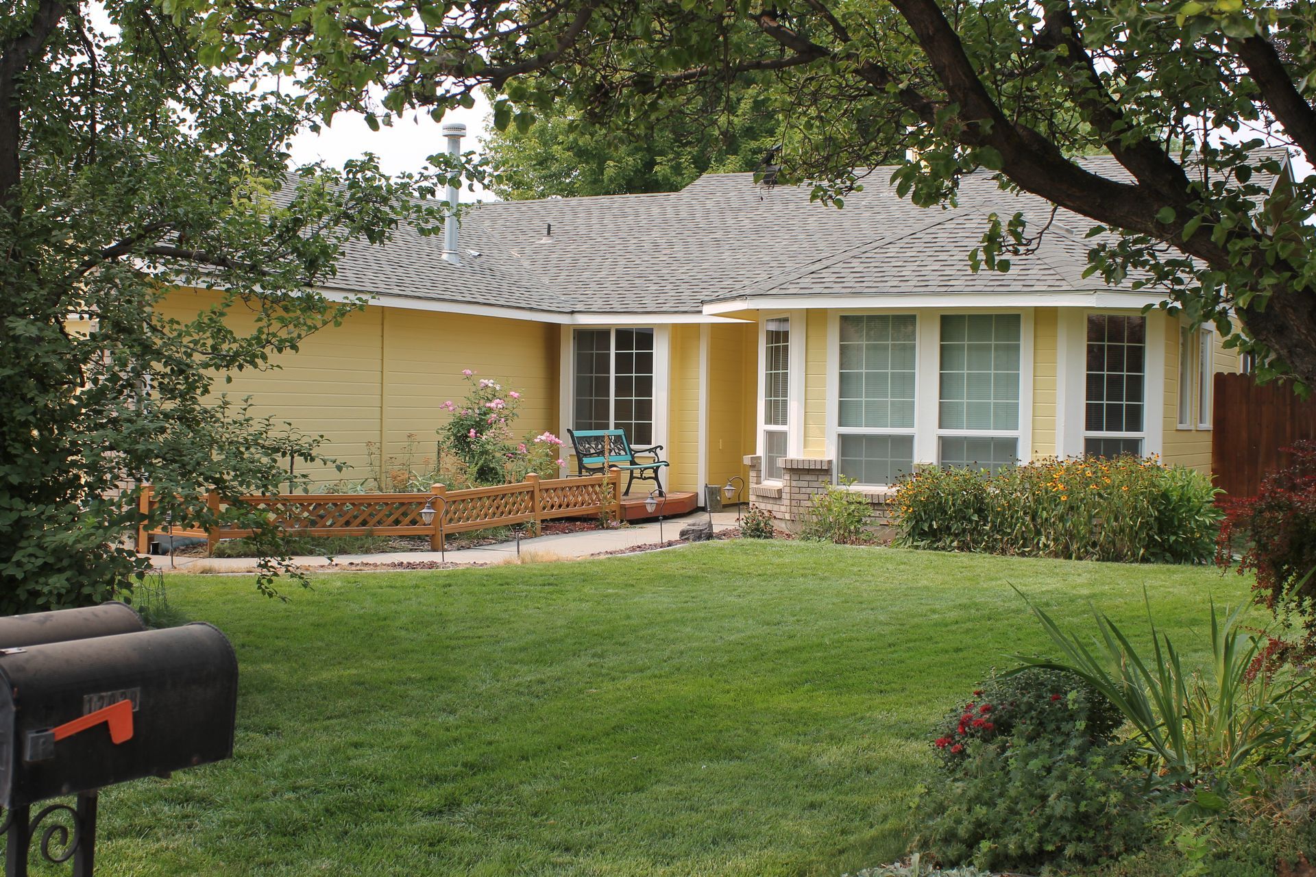 A large house with a basketball hoop in front of it.