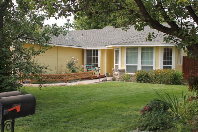 A large house with a lot of windows and a large air conditioner on the side of it.