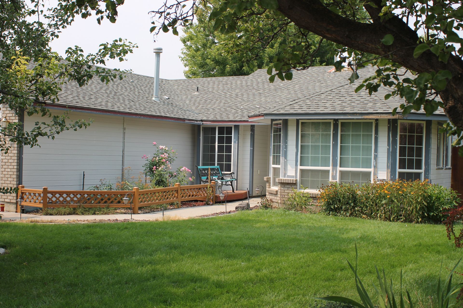 A large house with a basketball hoop in front of it.