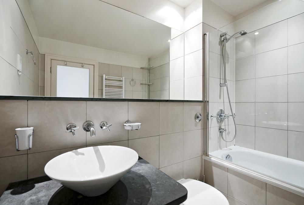 A bathroom with a sink a toilet and a bathtub