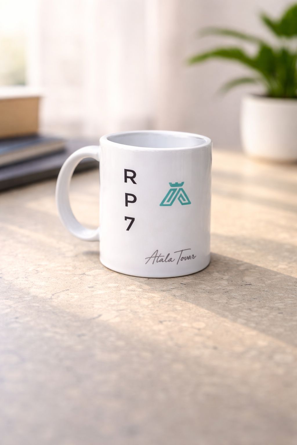 Two orange mugs on a wooden tray; one displays an inspirational quote, the other features an Atala logo.
