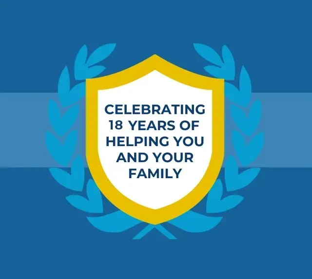 Blue award emblem with yellow shield and laurel wreath reading “Celebrating 18 years of helping you and your family.”