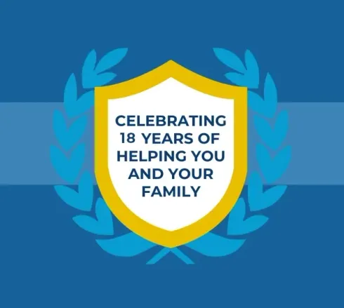 Blue award emblem with yellow shield and laurel wreath reading “Celebrating 18 years of helping you and your family.”