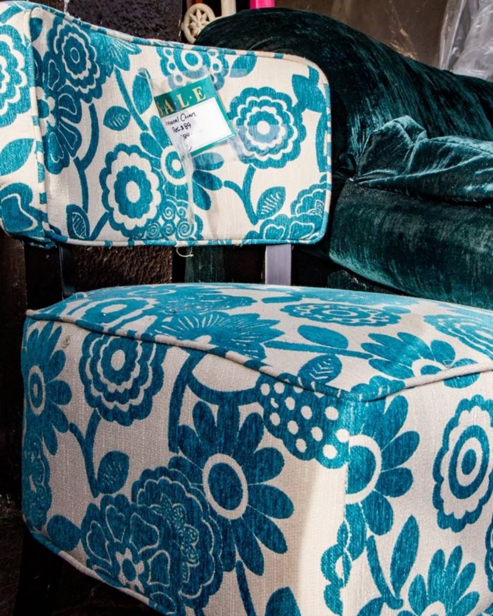 Turquoise floral-patterned chair and ottoman in a living room