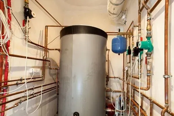 A room filled with pipes and a large tank.