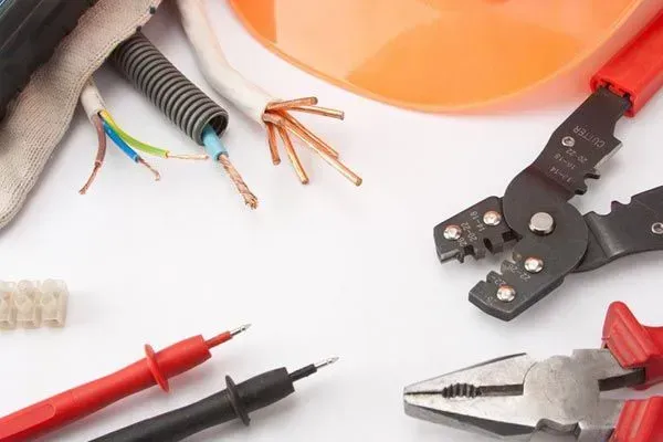 A bunch of electrical tools on a white surface