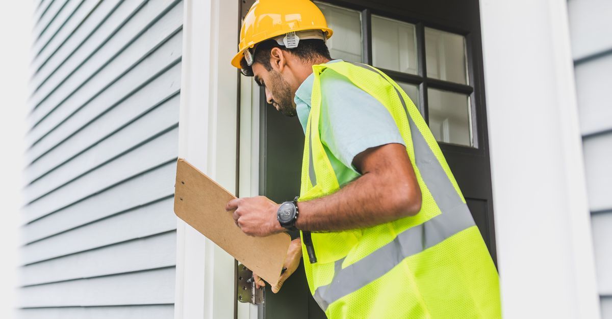 Home service business owner reviewing marketing performance beside a service van