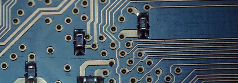 A close up of a blue and white electronic circuit board.