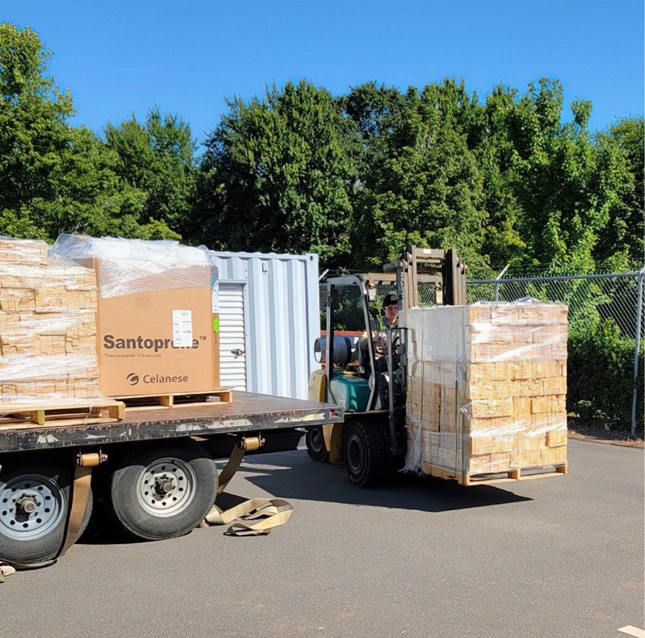 A forklift is carrying a box that says santos on it