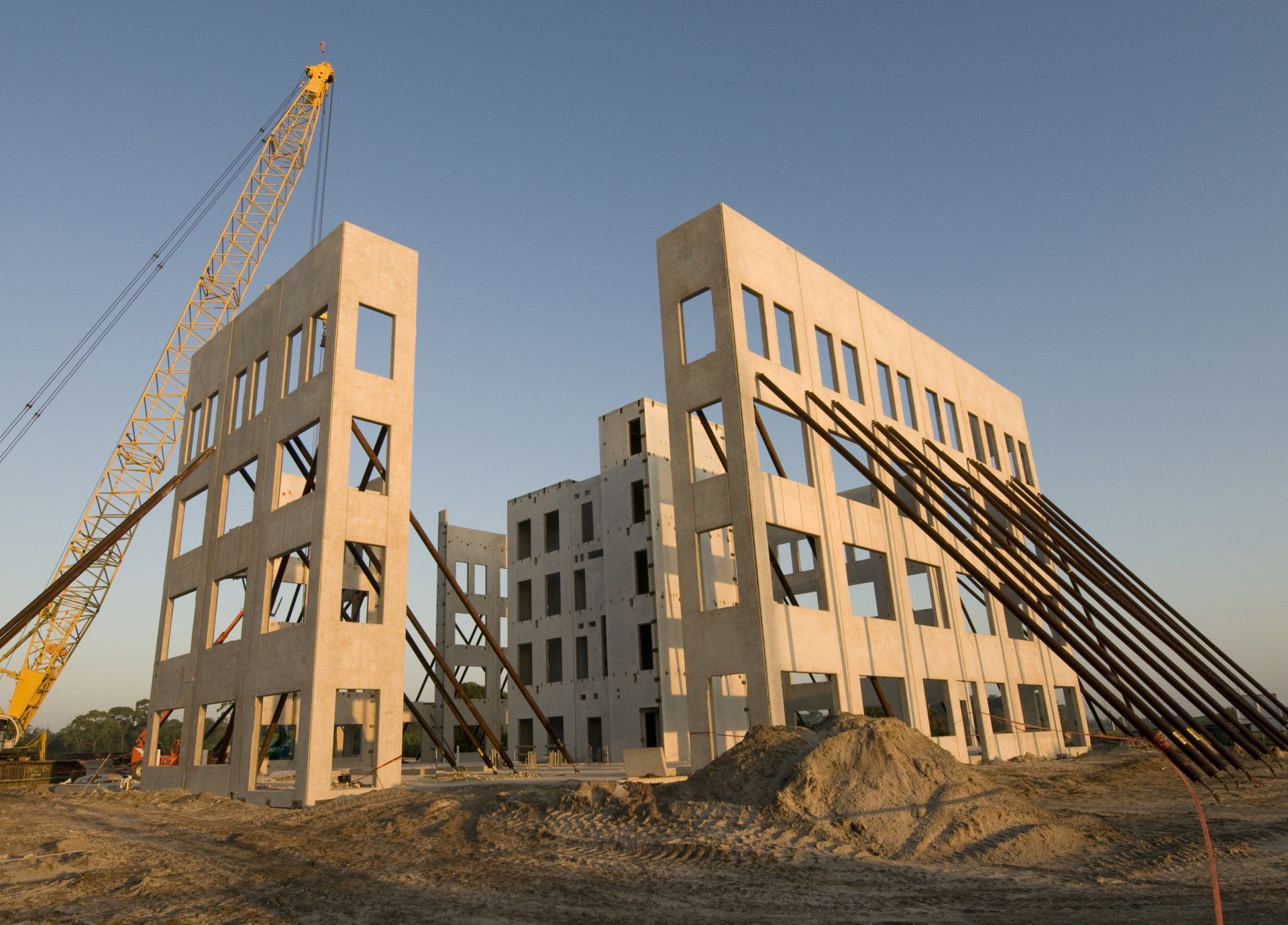 A large building under construction with a crane in the background