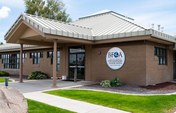 A brick building with a metal roof and a sign that says BFOA on it