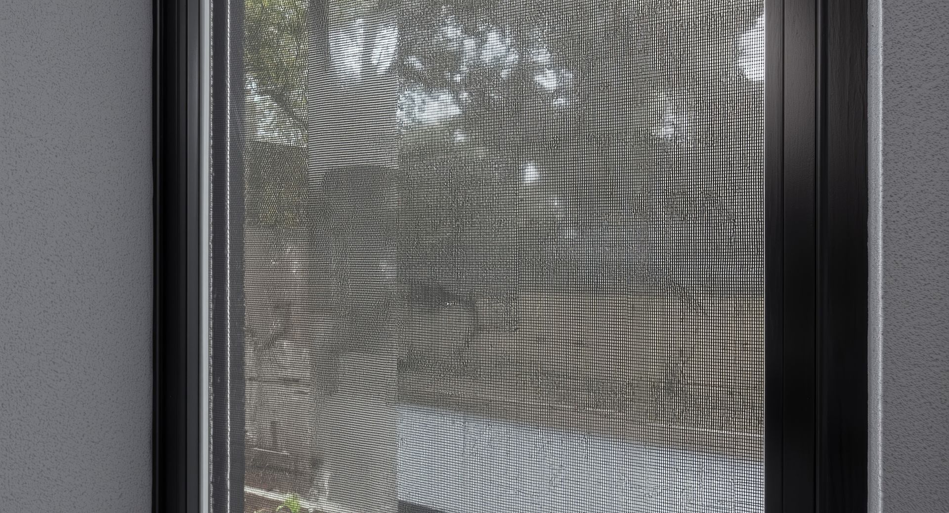 A window viewed through a fine mesh screen, showing distorted, repeating wave patterns over a blurry outdoor background.