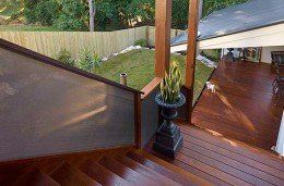 A Wooden Deck With Stairs Leading Up To It And A Glass Railing — Nambucca Glass in Nambucca Heads, NSW