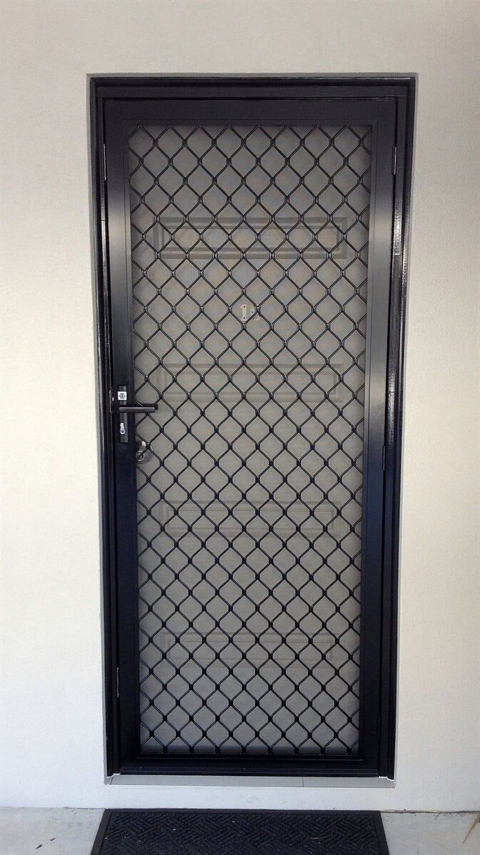 A Black Door With A Diamond Pattern On It Is On A White Wall — Nambucca Glass in Nambucca Heads, NSW