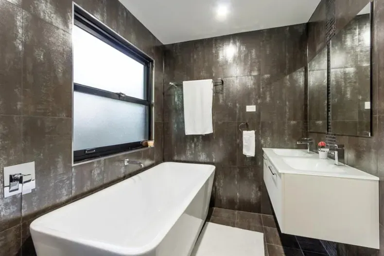 A Bathroom With A Tub, Sink, Mirror And Window — Nambucca Glass in Nambucca Heads, NSW