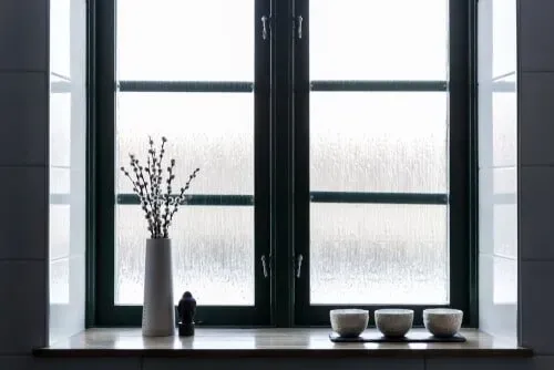 A Window Sill With A Vase Of Flowers And Three Bowls On It — Nambucca Glass in Nambucca Heads, NSW