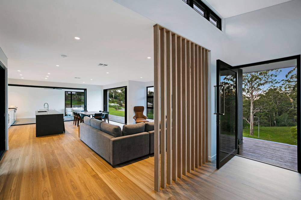 A Living Room With A Couch And An Open Aluminium Door — Nambucca Glass in Nambucca Heads, NSW
