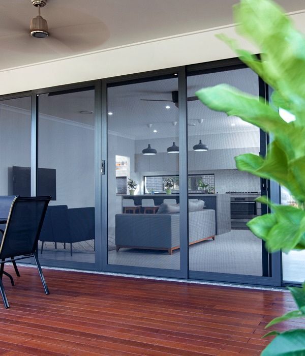 A Patio With Sliding Glass Doors Leading To A Living Room — Nambucca Glass In Nambucca Heads, NSW