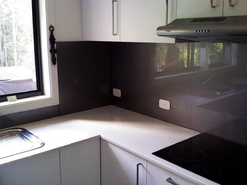 A Kitchen With White Cabinets And A Black Stove Top — Nambucca Glass in Nambucca Heads, NSW