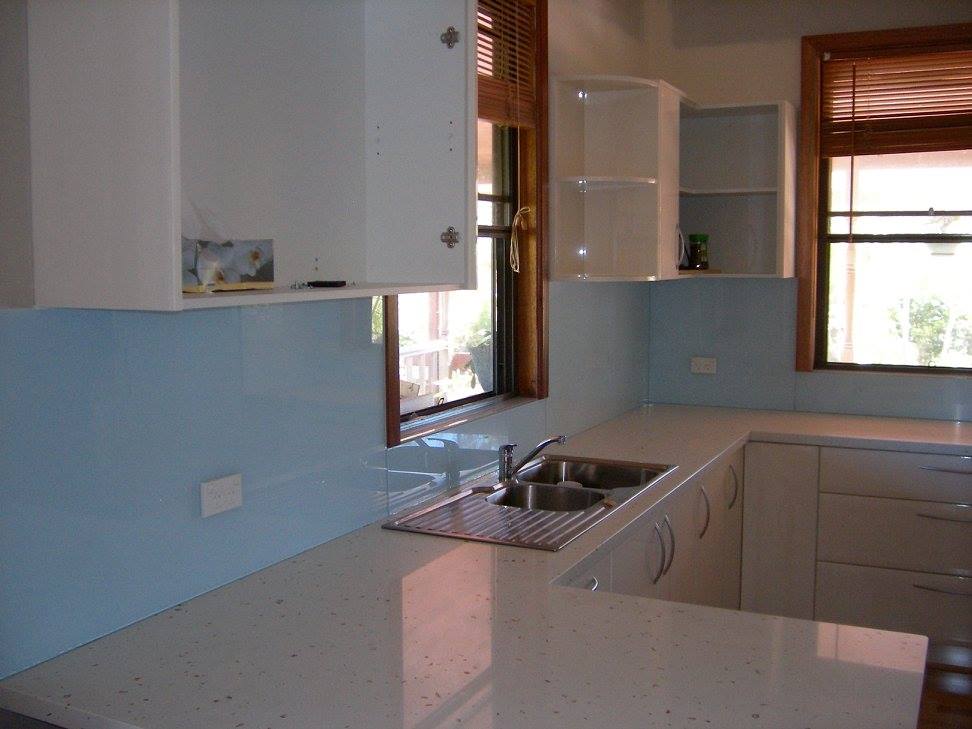 A Kitchen With A Sink , Cabinets And A Window — Nambucca Glass in Nambucca Heads, NSW