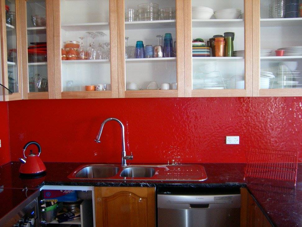 A Kitchen With Red Cabinets And A Sink — Nambucca Glass in Nambucca Heads, NSW
