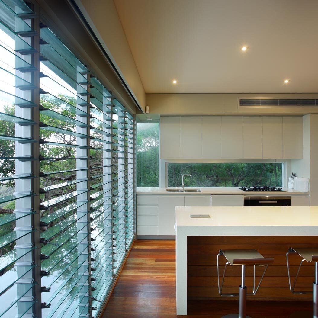 A Kitchen With A Large Island And Stools — Nambucca Glass in Nambucca Heads, NSW