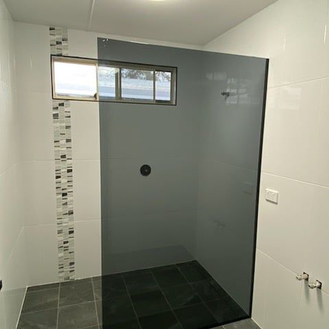 A Bathroom With A Walk In Shower And A Window — Nambucca Glass in Nambucca Heads, NSW