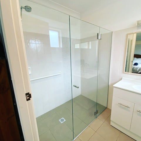 A Bathroom With A Walk In Shower And A Sink — Nambucca Glass in Nambucca Heads, NSW