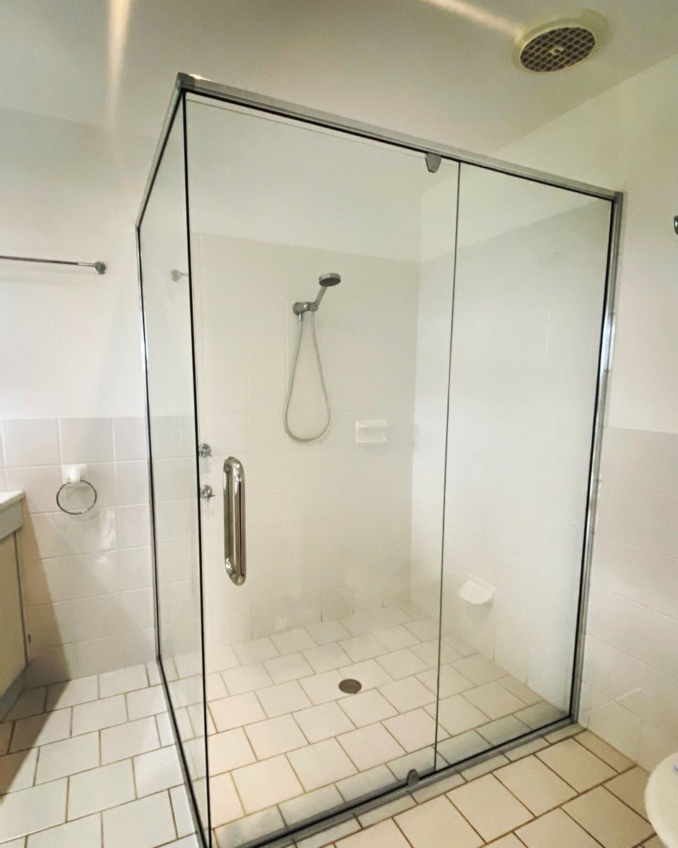 A Bathroom With A Glass Shower Door And A Toilet — Nambucca Glass in Nambucca Heads, NSW