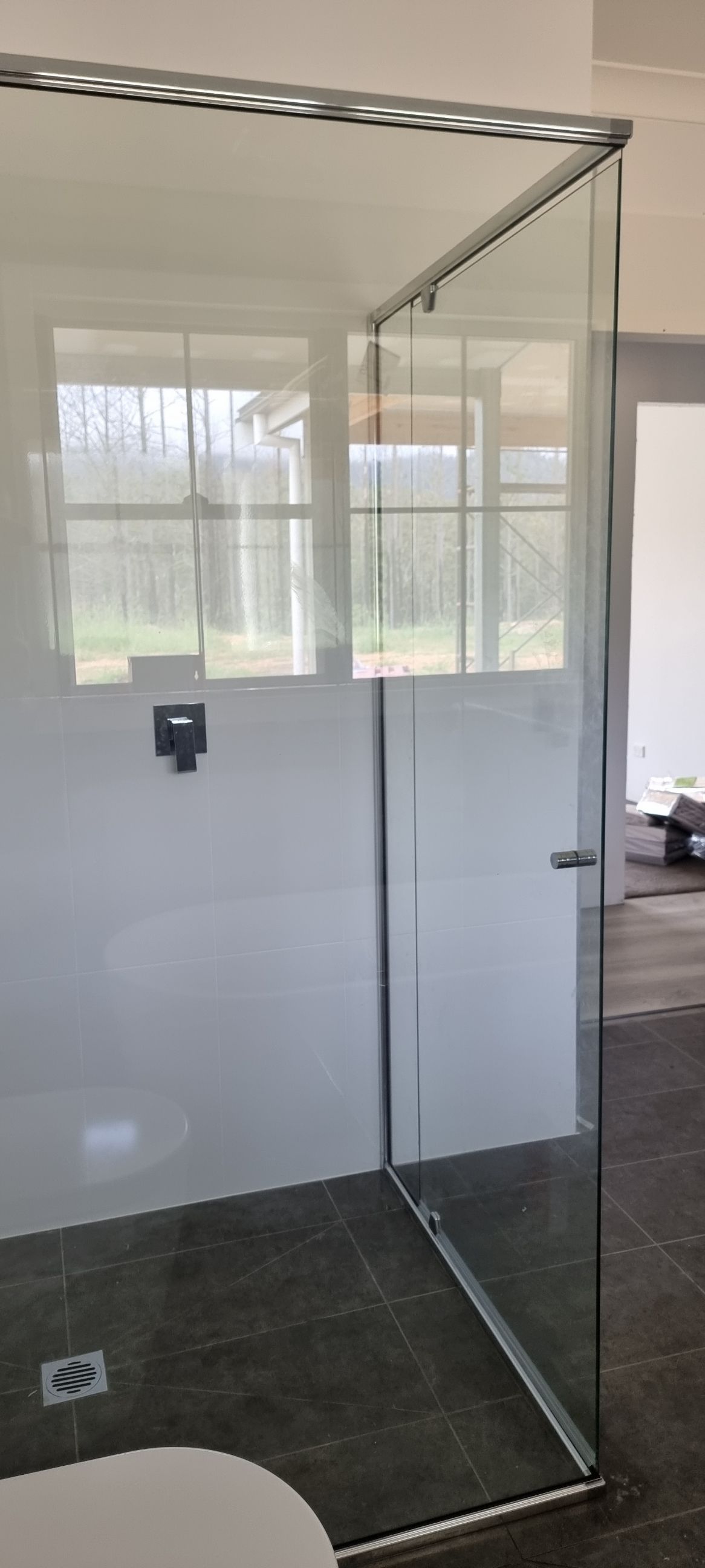 A Bathroom With A Glass Shower Door And A Toilet — Nambucca Glass in Nambucca Heads, NSW