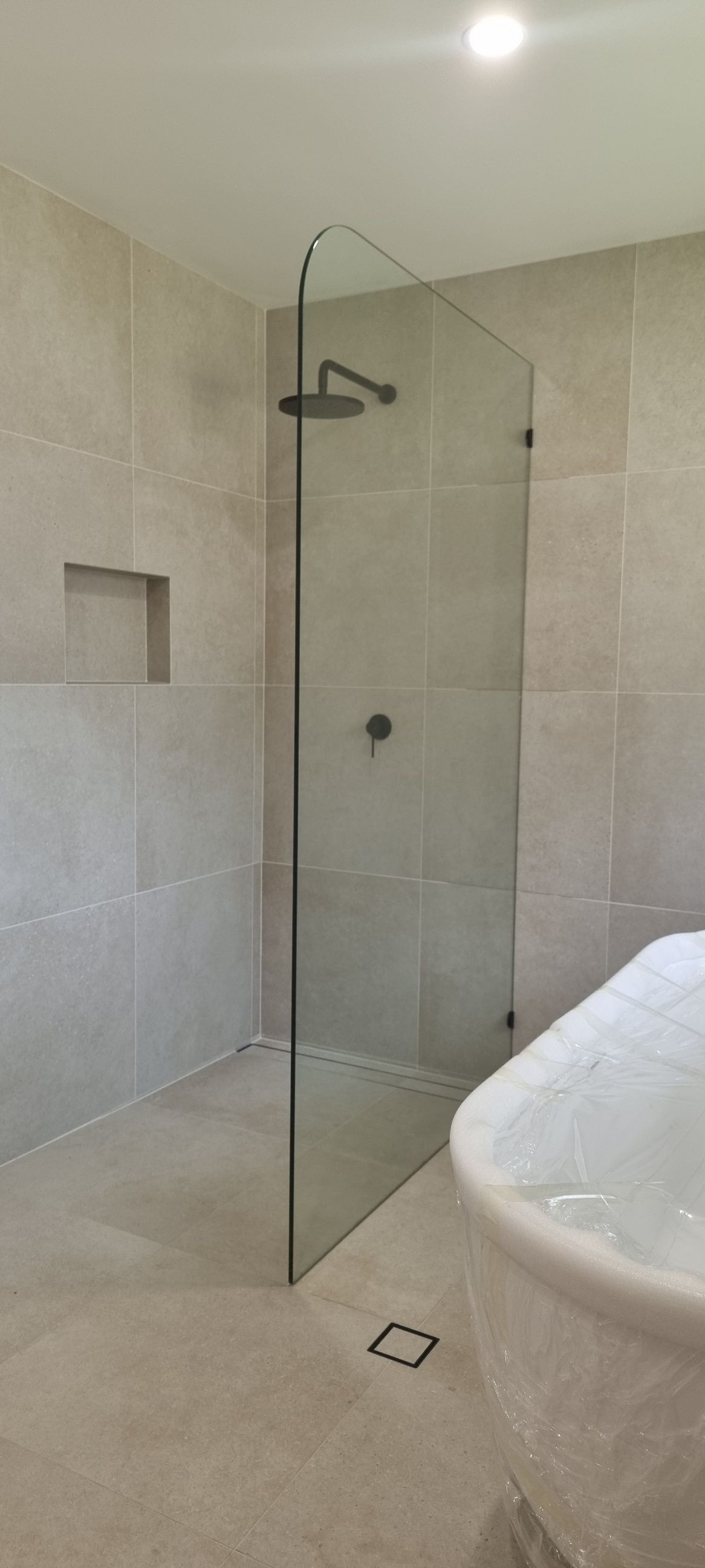 A Bathroom With A Walk In Shower And A Bathtub — Nambucca Glass in Nambucca Heads, NSW