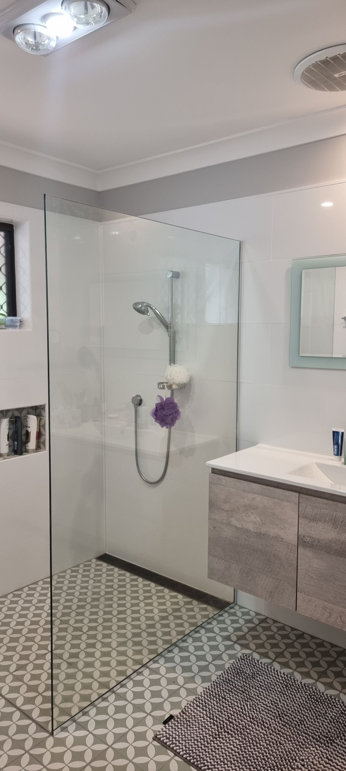 A Bathroom With A Walk In Shower , Sink And Mirror — Nambucca Glass in Nambucca Heads, NSW