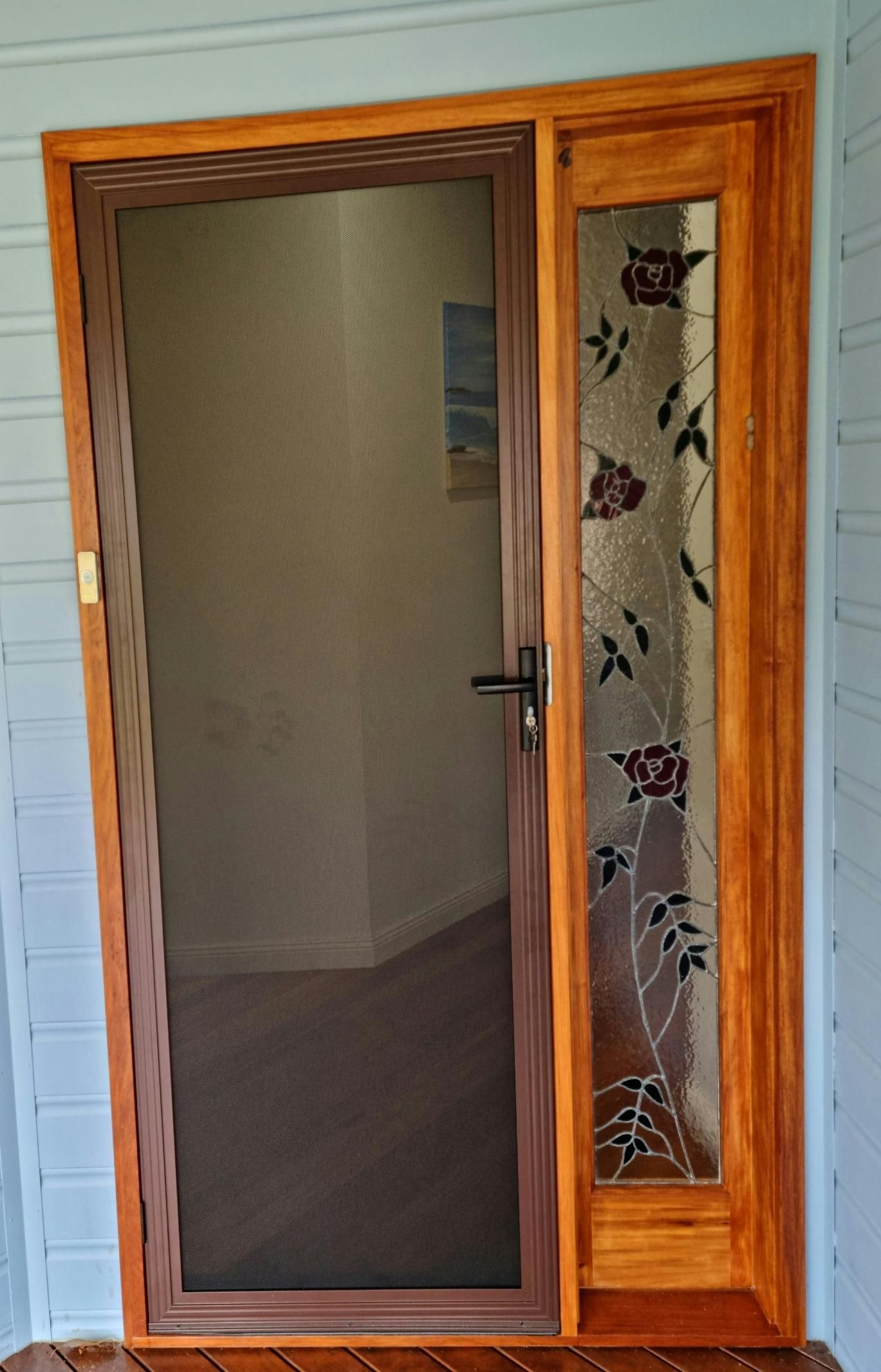 A Screen Door With A Floral Design On It — Nambucca Glass in Nambucca Heads, NSW