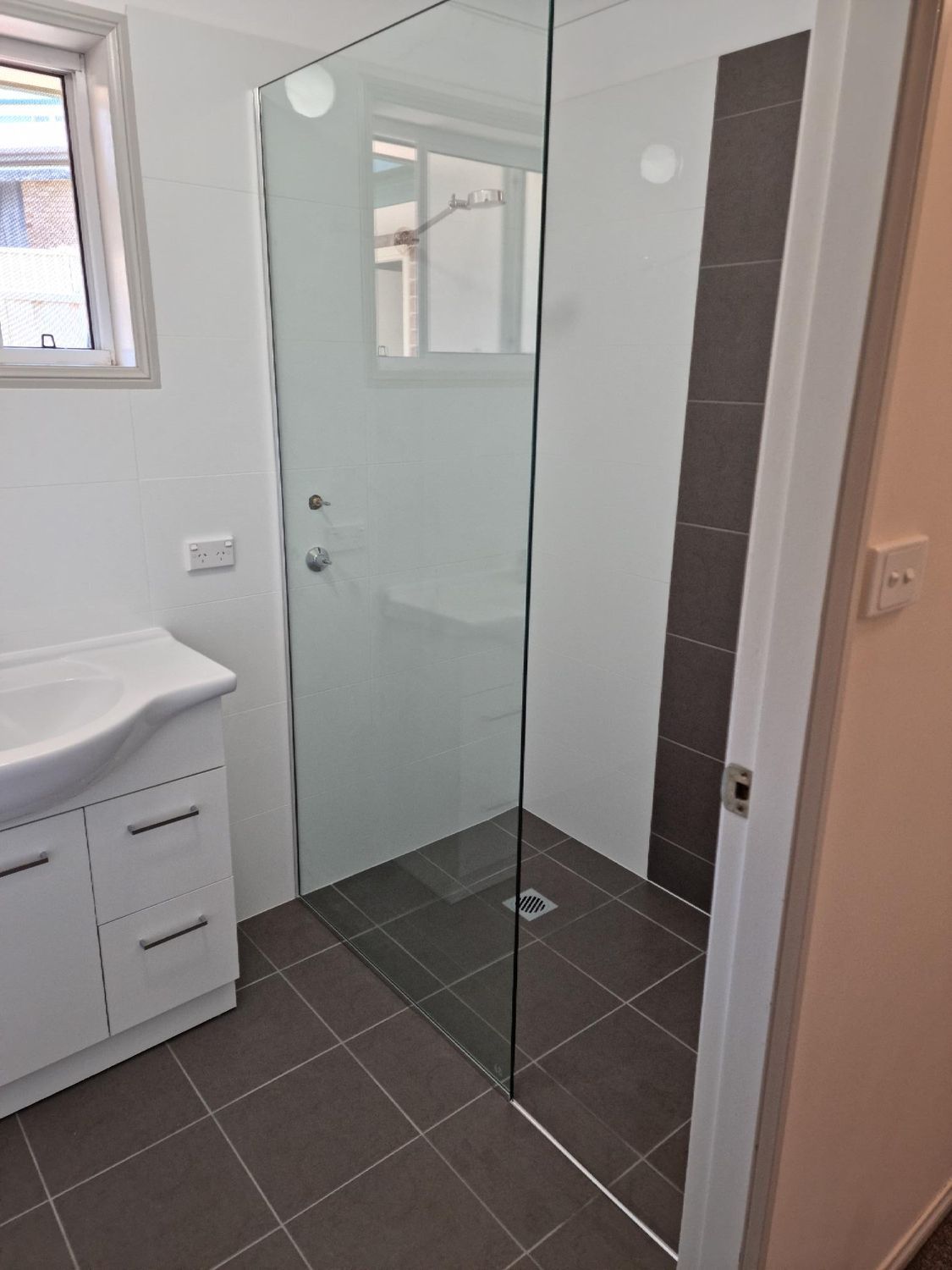 A Bathroom With A Walk In Shower And A Sink — Nambucca Glass in Nambucca Heads, NSW
