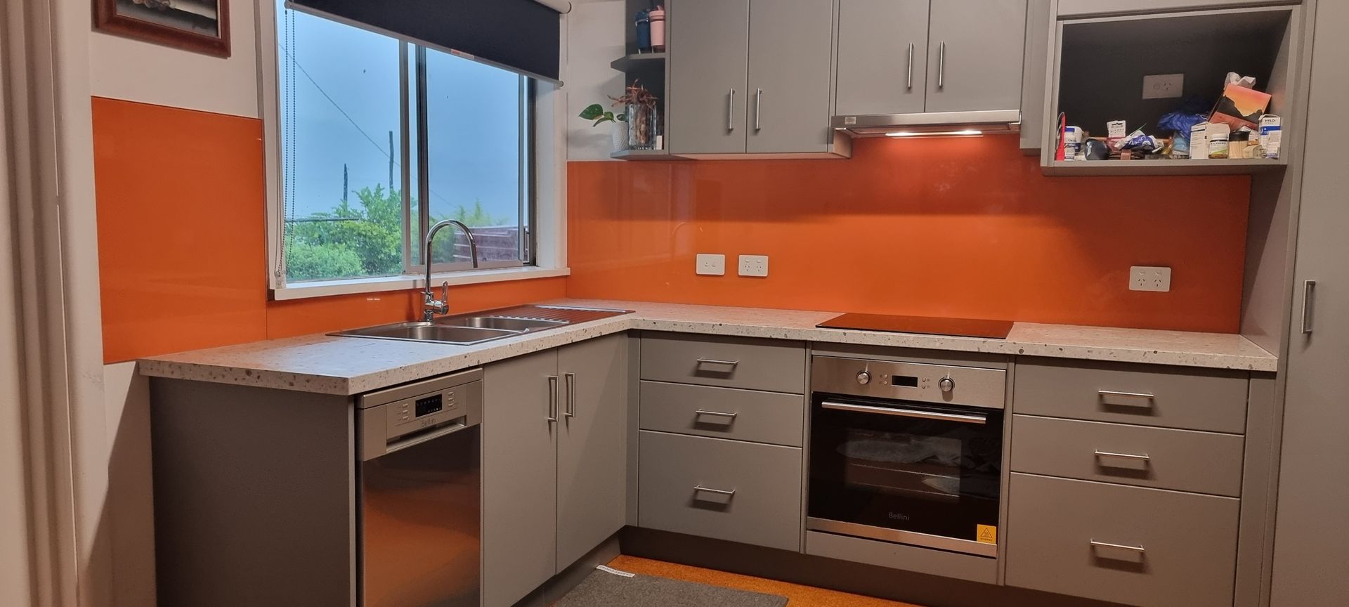 A Kitchen With Gray Cabinets And Orange Walls — Nambucca Glass in Nambucca Heads, NSW