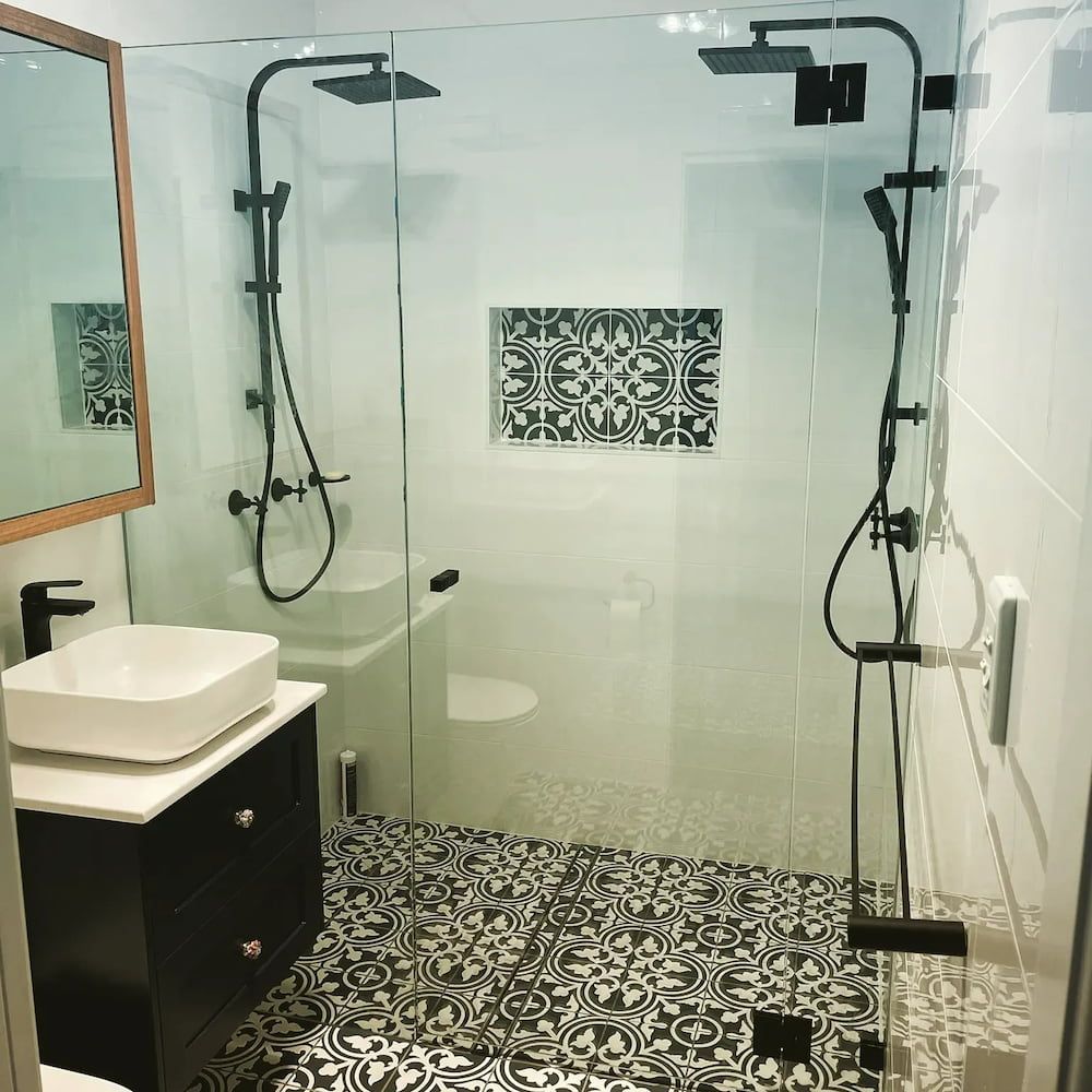 A Bathroom With A Sink, Toilet, Shower And Mirror — Nambucca Glass in Nambucca Heads, NSW