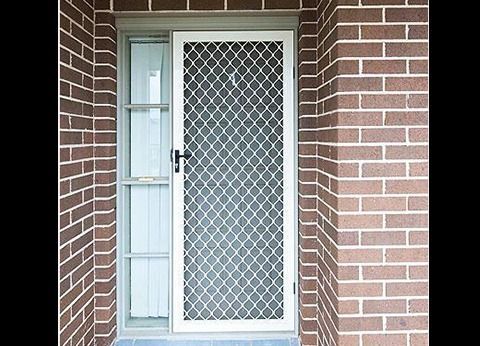 A Brick Wall With A White Door And A Window — Nambucca Glass in Nambucca Heads, NSW