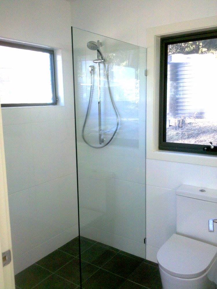 A Bathroom With A Toilet , Shower And Window — Nambucca Glass in Nambucca Heads, NSW