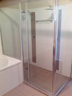 A Bathroom With A Bathtub , Shower , And Mirror — Nambucca Glass in Nambucca Heads, NSW