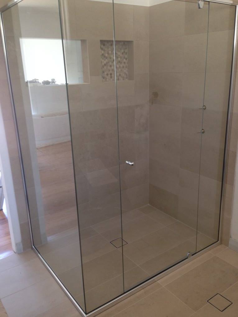A Bathroom With A Shower Stall With Sliding Glass Doors — Nambucca Glass in Nambucca Heads, NSW