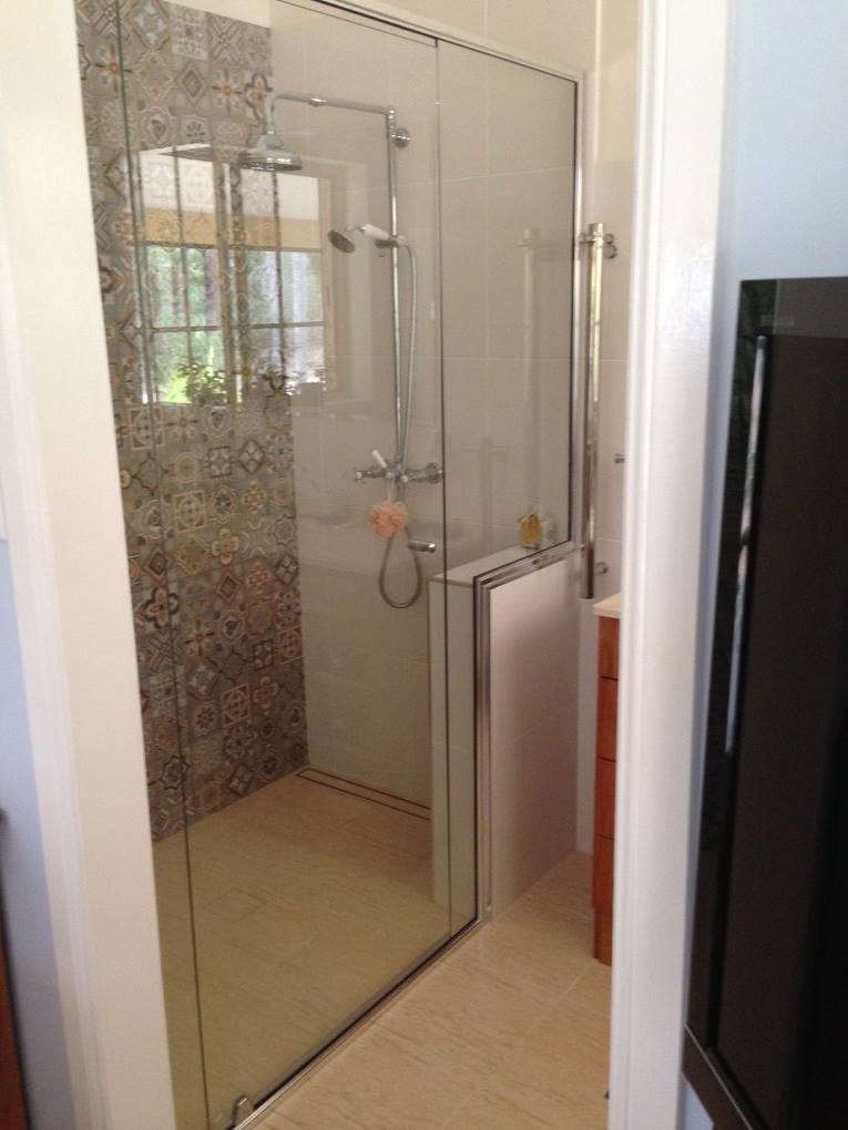 A Bathroom With A Walk In Shower And A Television — Nambucca Glass in Nambucca Heads, NSW