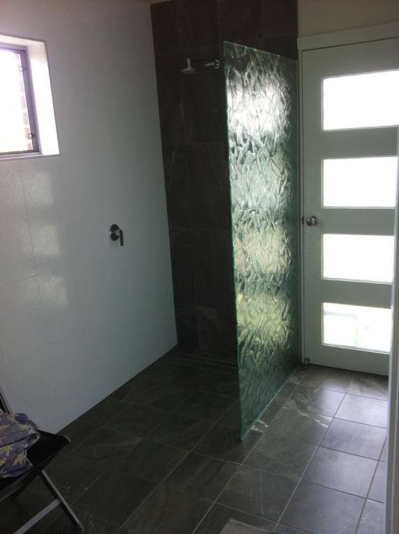 A Bathroom With A Walk In Shower And A Door — Nambucca Glass in Nambucca Heads, NSW