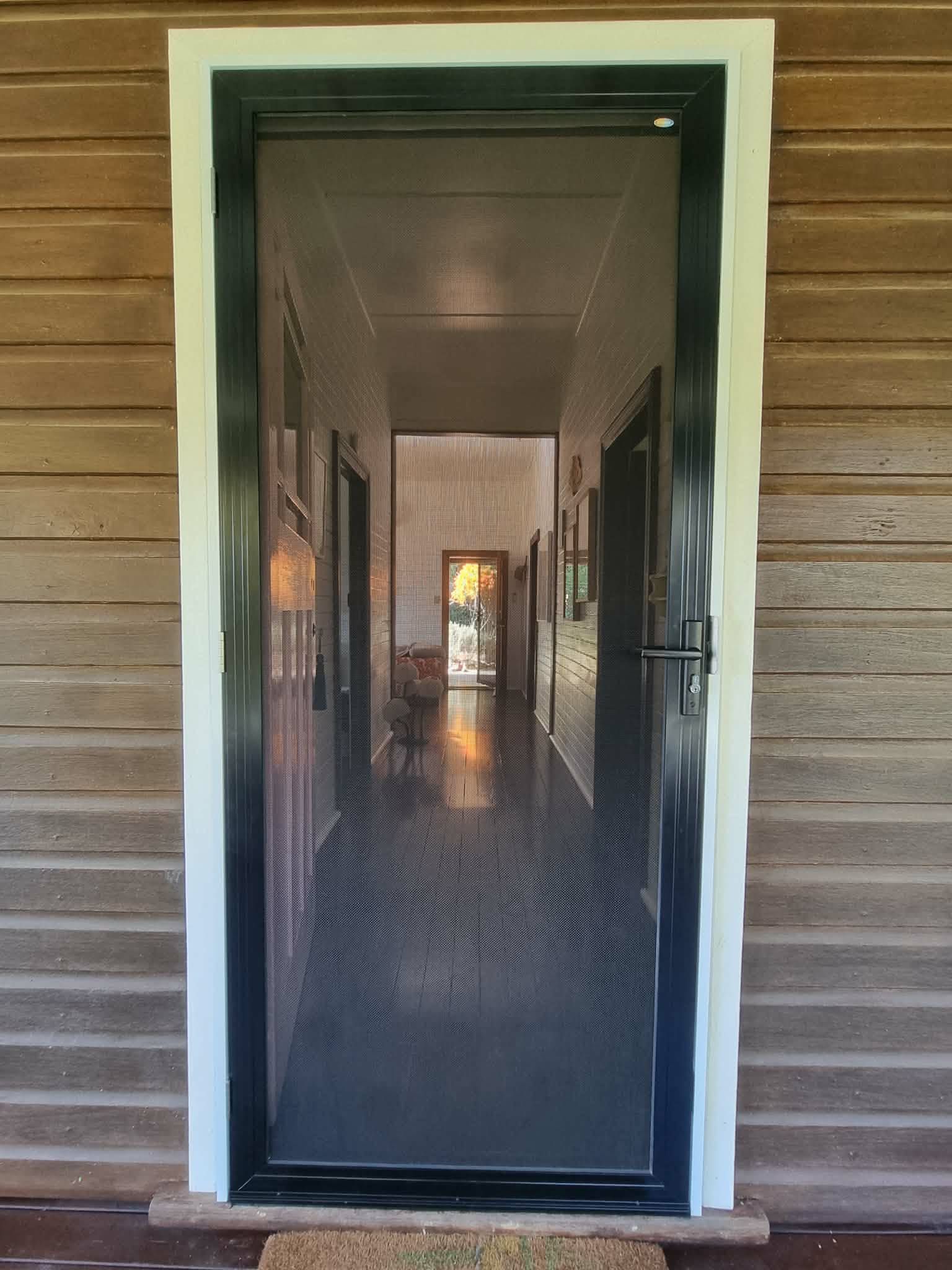 Open Front Door to a Long Narrow Hallway With Patterned Floor — Nambucca Glass in Nambucca Heads, NSW