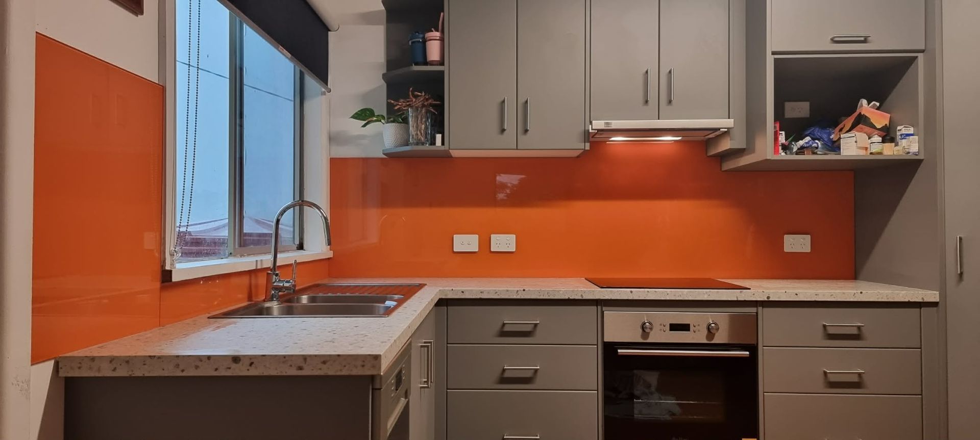 Modern Kitchen With Orange Backsplash — Nambucca Glass in Nambucca Heads, NSW