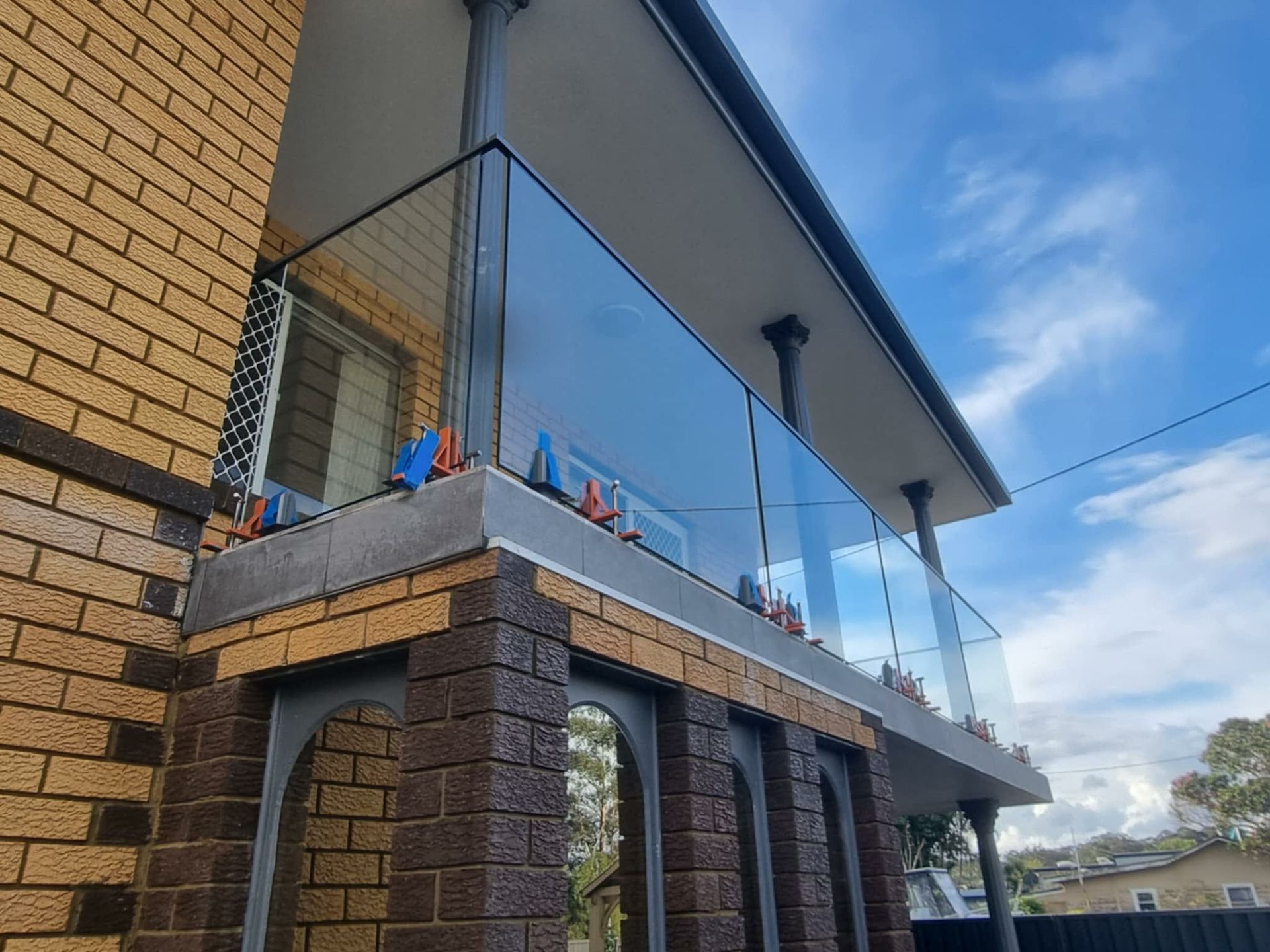 Modern Brick House With Glass Balcony — Nambucca Glass in Nambucca Heads, NSW