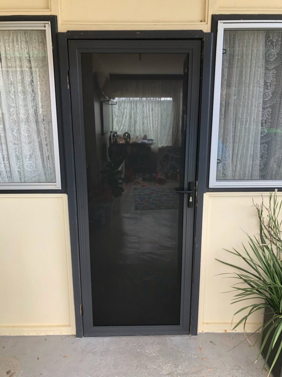 Framed Glass Front Door with Sidelights on A Beige House Exterior — Nambucca Glass in Nambucca Heads, NSW
