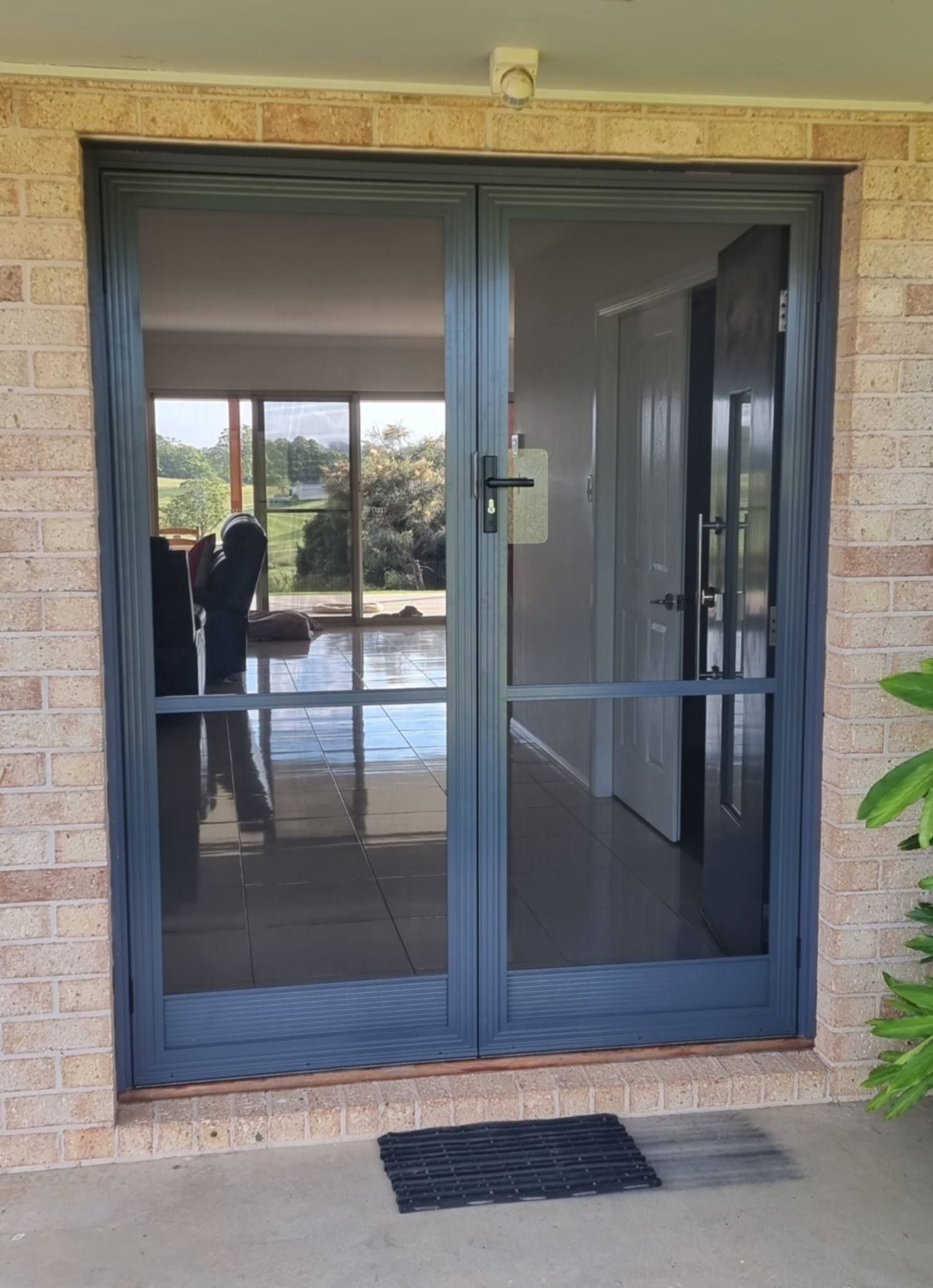 Blue Mesh Screen Door at A Stone Entryway — Nambucca Glass in Nambucca Heads, NSW