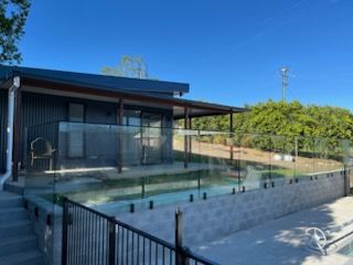 Modern House With a Fenced Backyard Pool — Nambucca Glass in Nambucca Heads, NSW