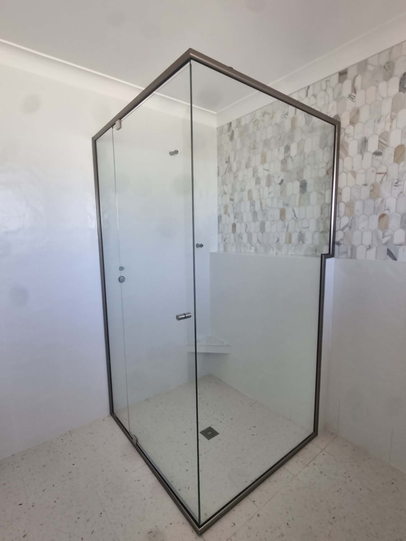 Glass Shower Enclosure with Black Metal Frame in A Tiled Bathroom — Nambucca Glass in Nambucca Heads, NSW