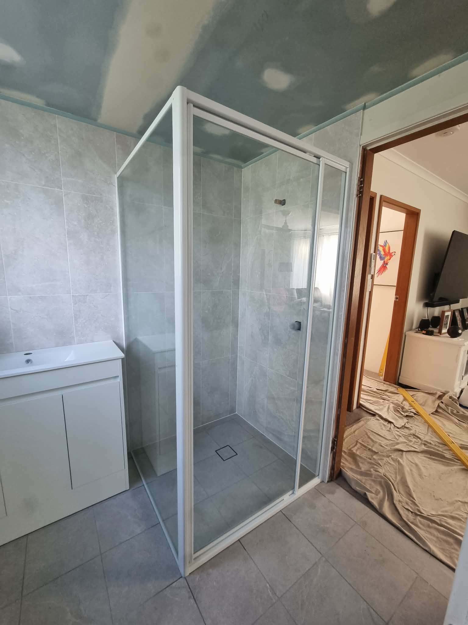 Small Bathroom With a Glass Shower Enclosure — Nambucca Glass in Nambucca Heads, NSW
